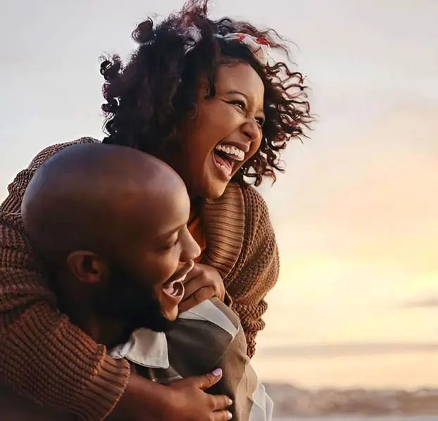 Happy couple laughing together, symbolizing love, trust, and relationship happiness.