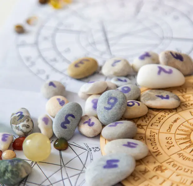 Numerology stones arranged with engraved numbers.
