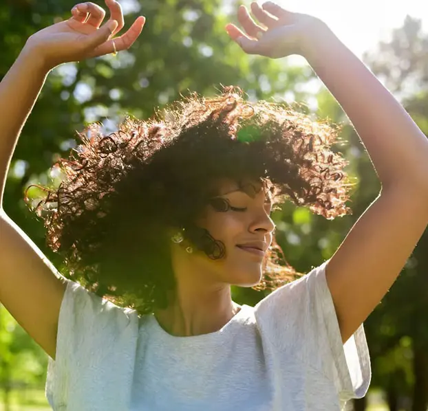 Joyful woman embracing positive energy.