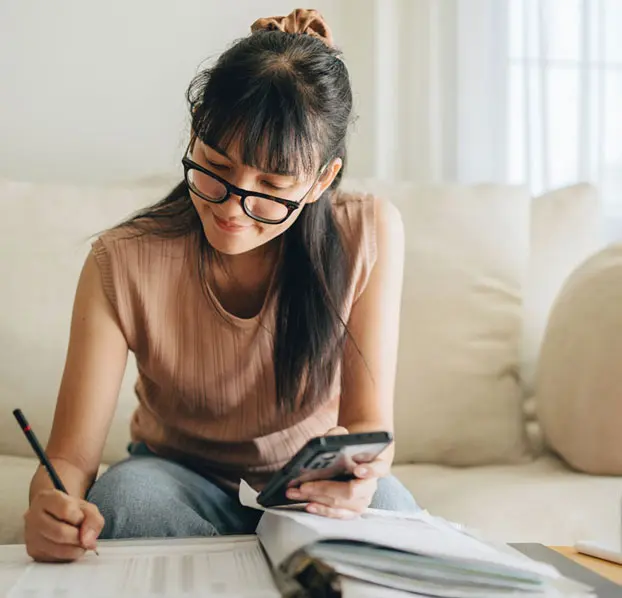 Woman reviewing financial paperwork.