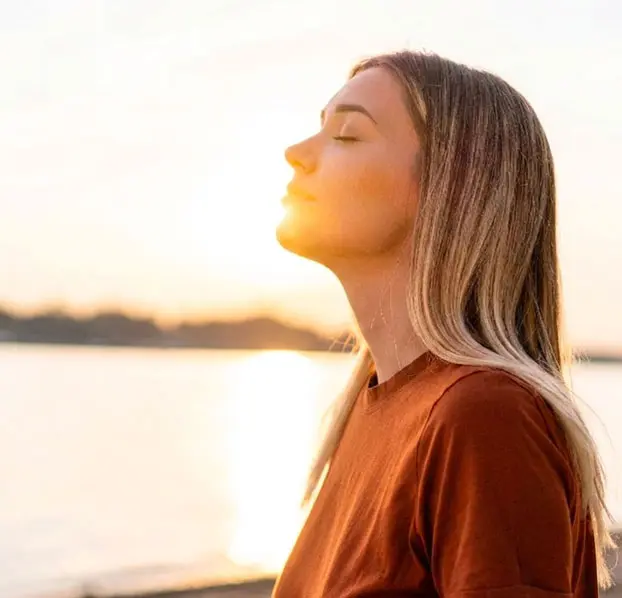 Peaceful woman embracing a moment of spiritual reflection.
